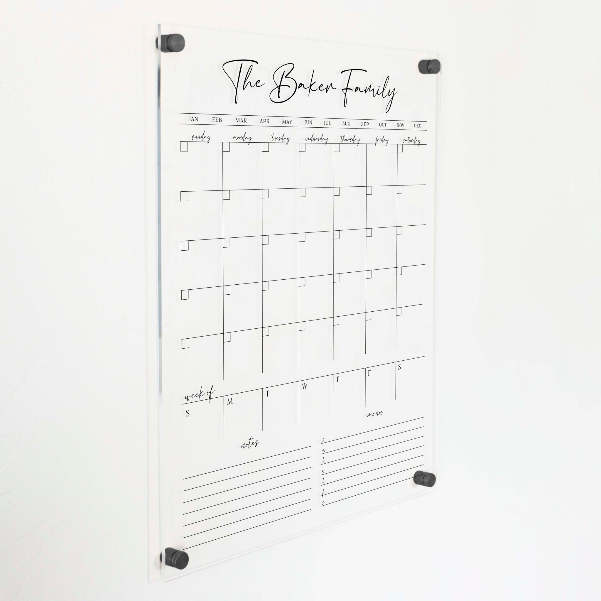 A Dry-erase calendar with a monthly and weekly format made of acrylic hanging on the wall
