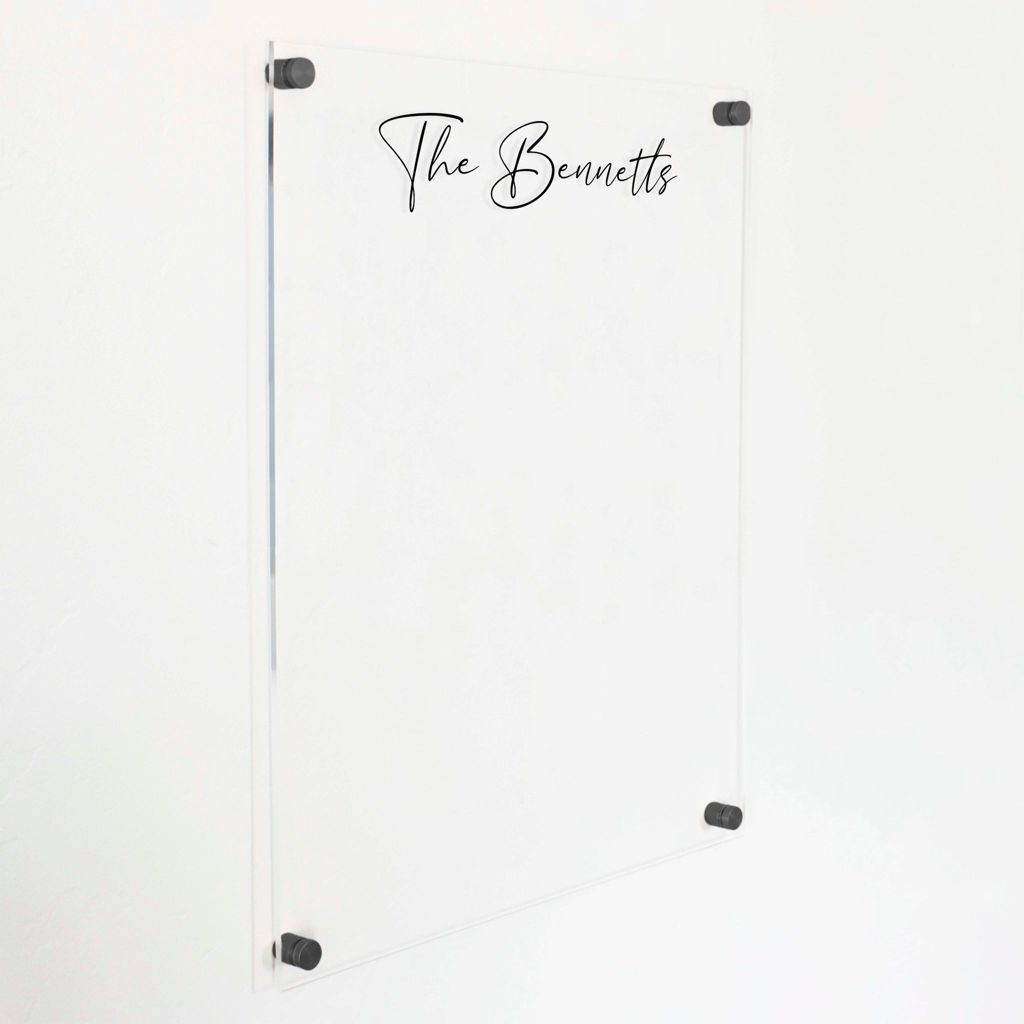 A dry-erase board made of clear acrylic with a custom title up top