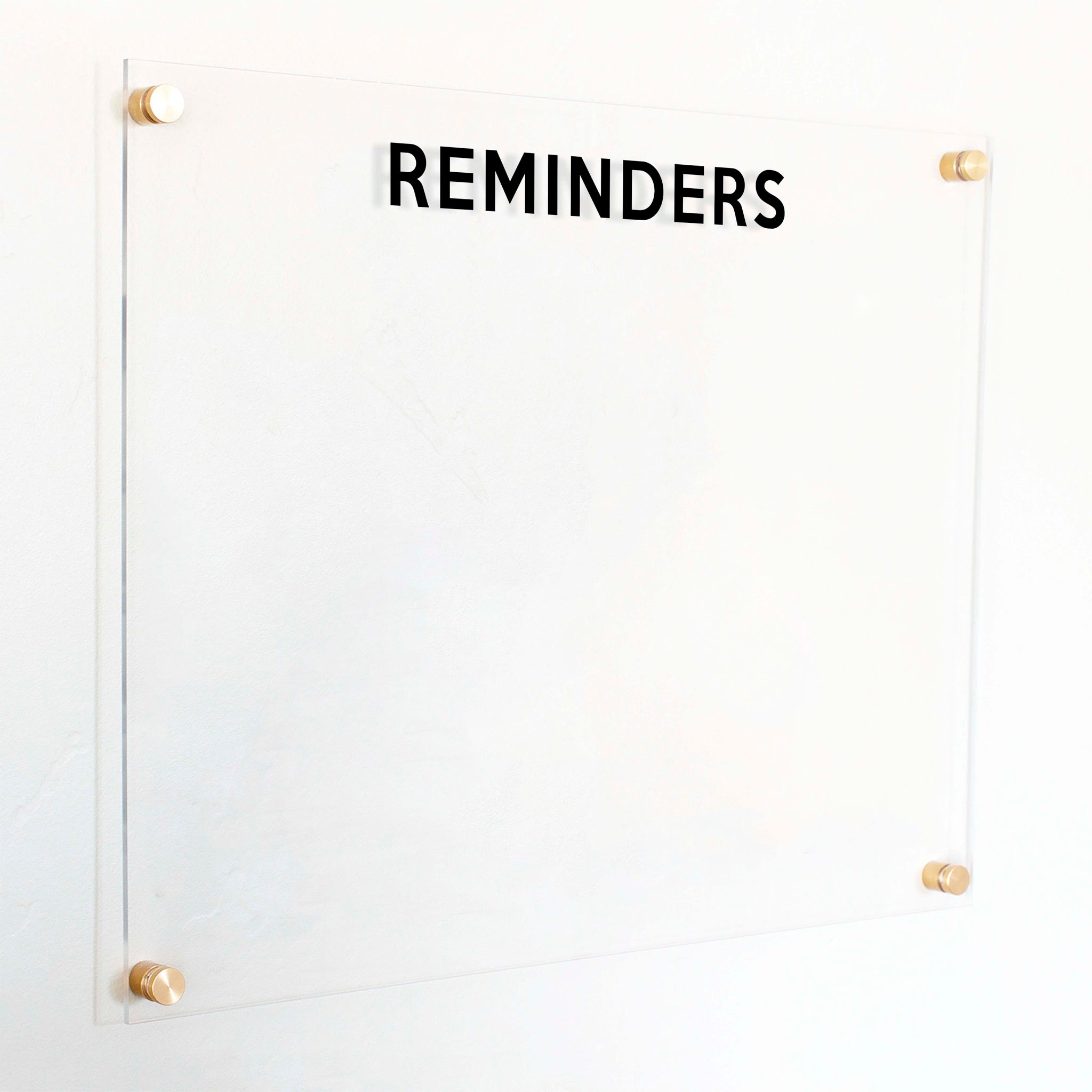 A dry-erase board made of clear acrylic with a custom title up top