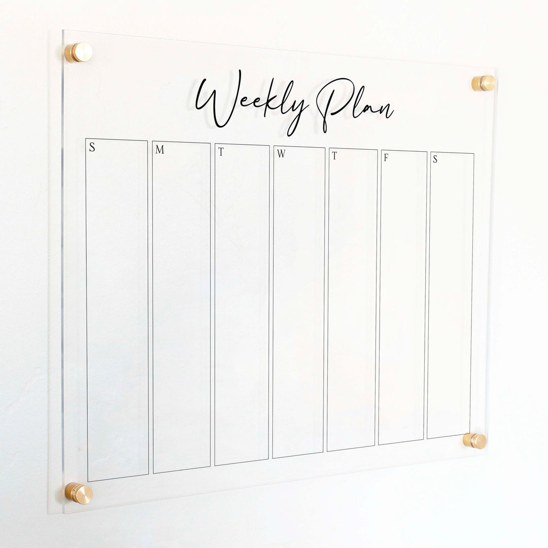A Dry-erase weekly calender made of acrylic hanging on the wall