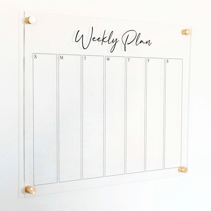 A Dry-erase weekly calender made of acrylic hanging on the wall