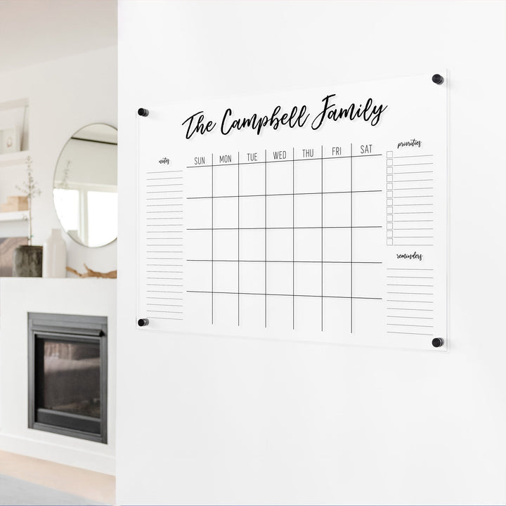 A Dry-erase monthly calender made of acrylic hanging on the wall