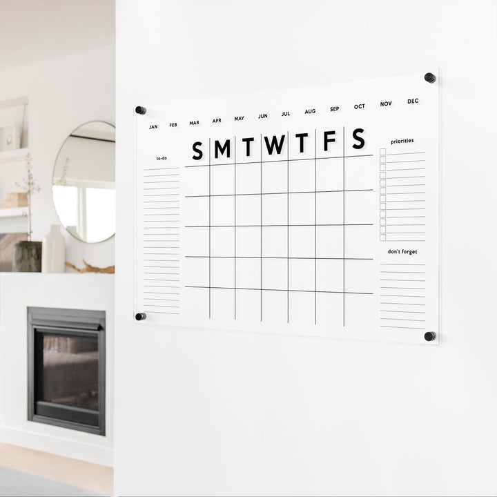 A Dry-erase monthly calender made of acrylic hanging on the wall