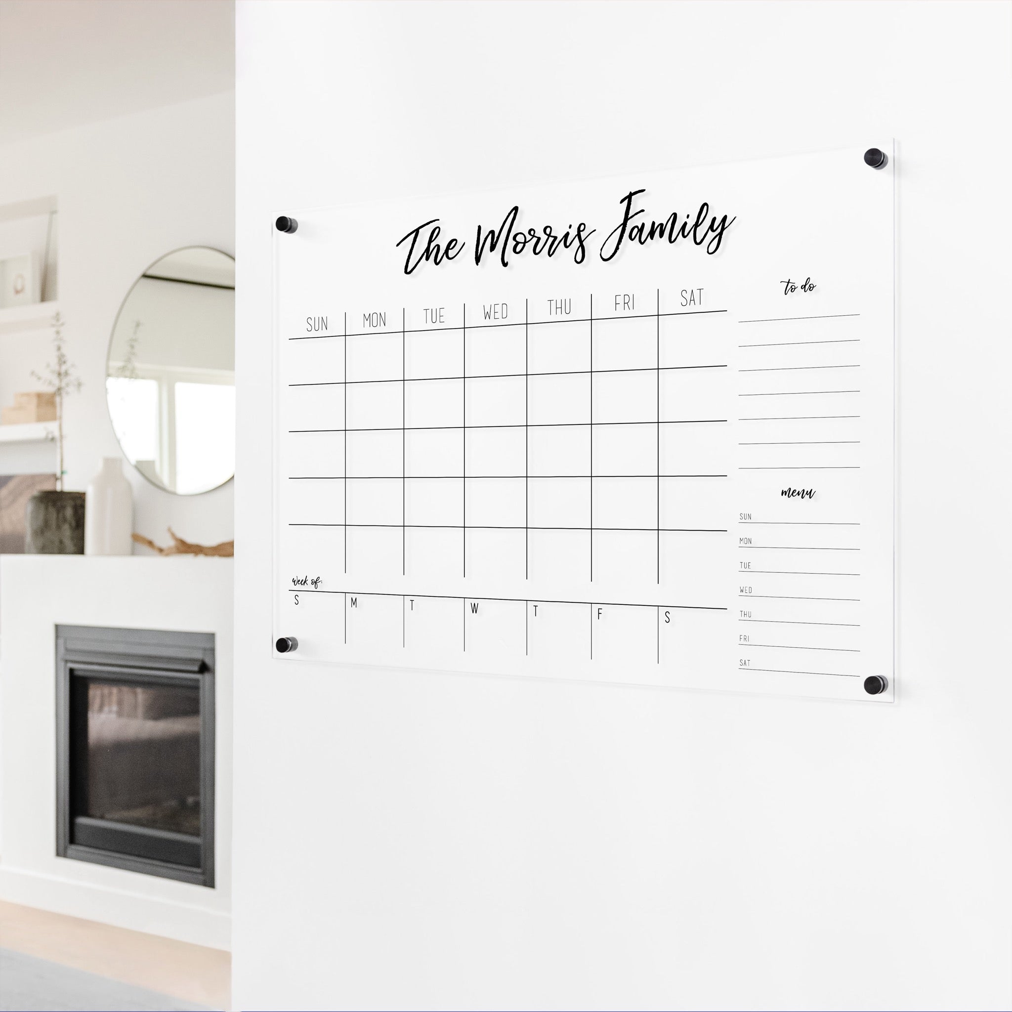 A Dry-erase calendar with a monthly and weekly format made of acrylic hanging on the wall