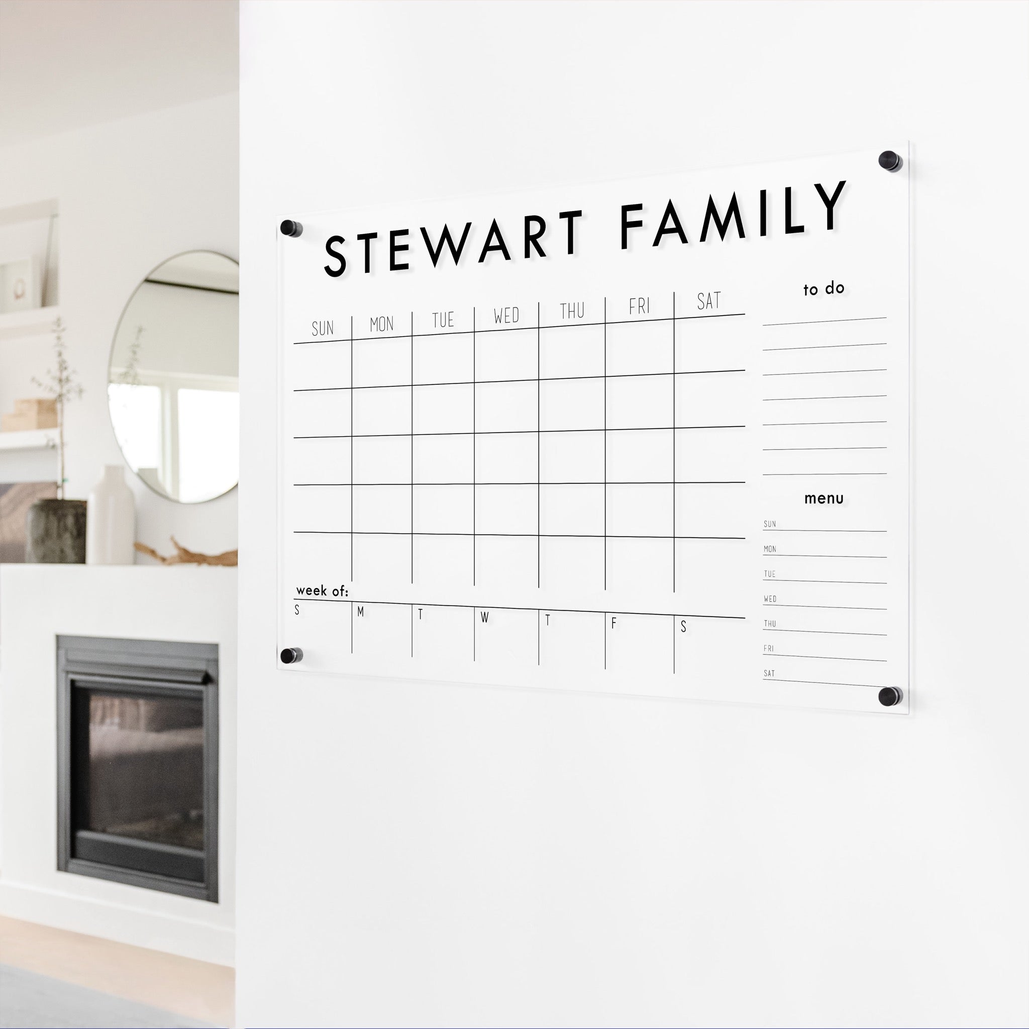 A Dry-erase calendar with a monthly and weekly format made of acrylic hanging on the wall