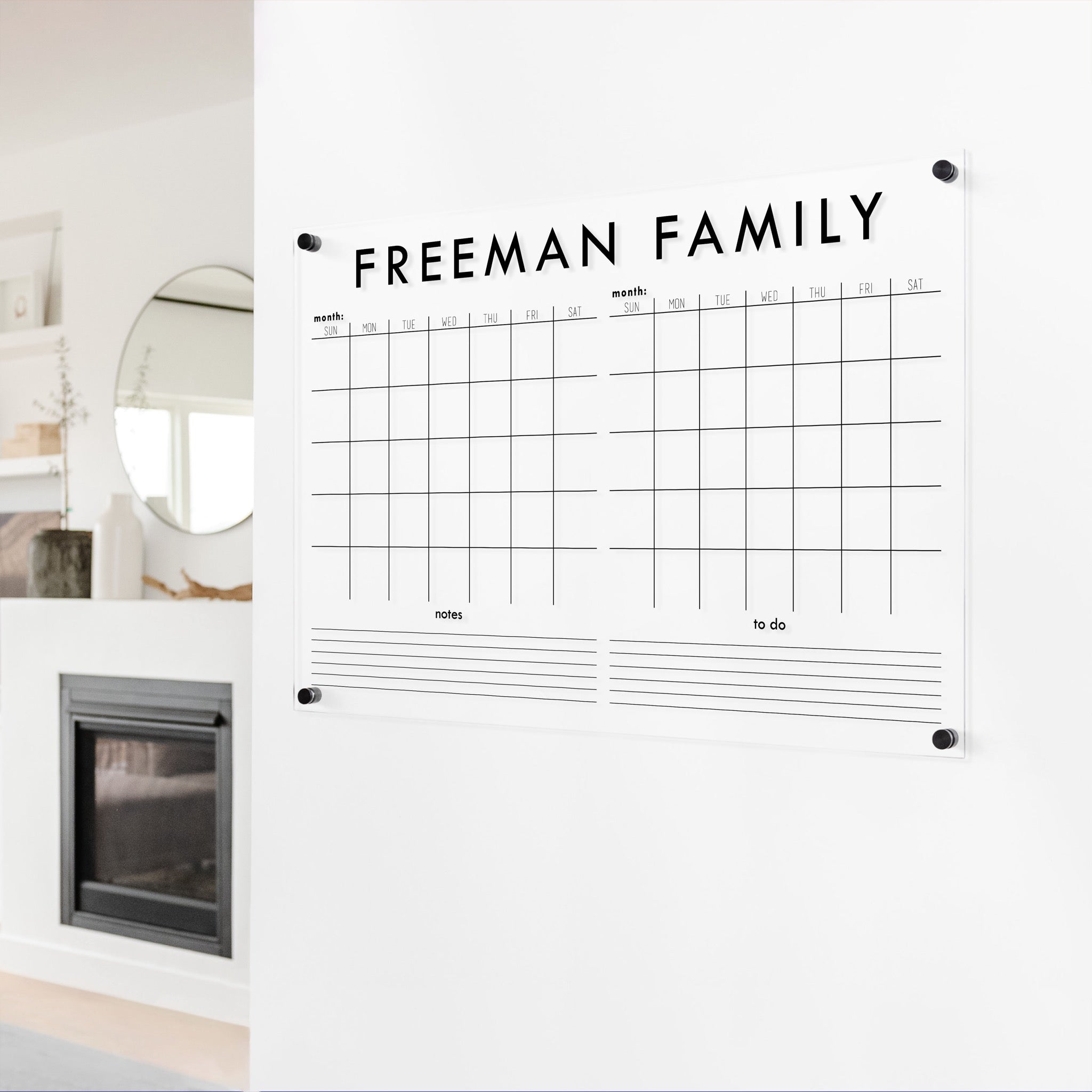 A Dry-erase acrylic calendar with a two month design format hanging on the wall