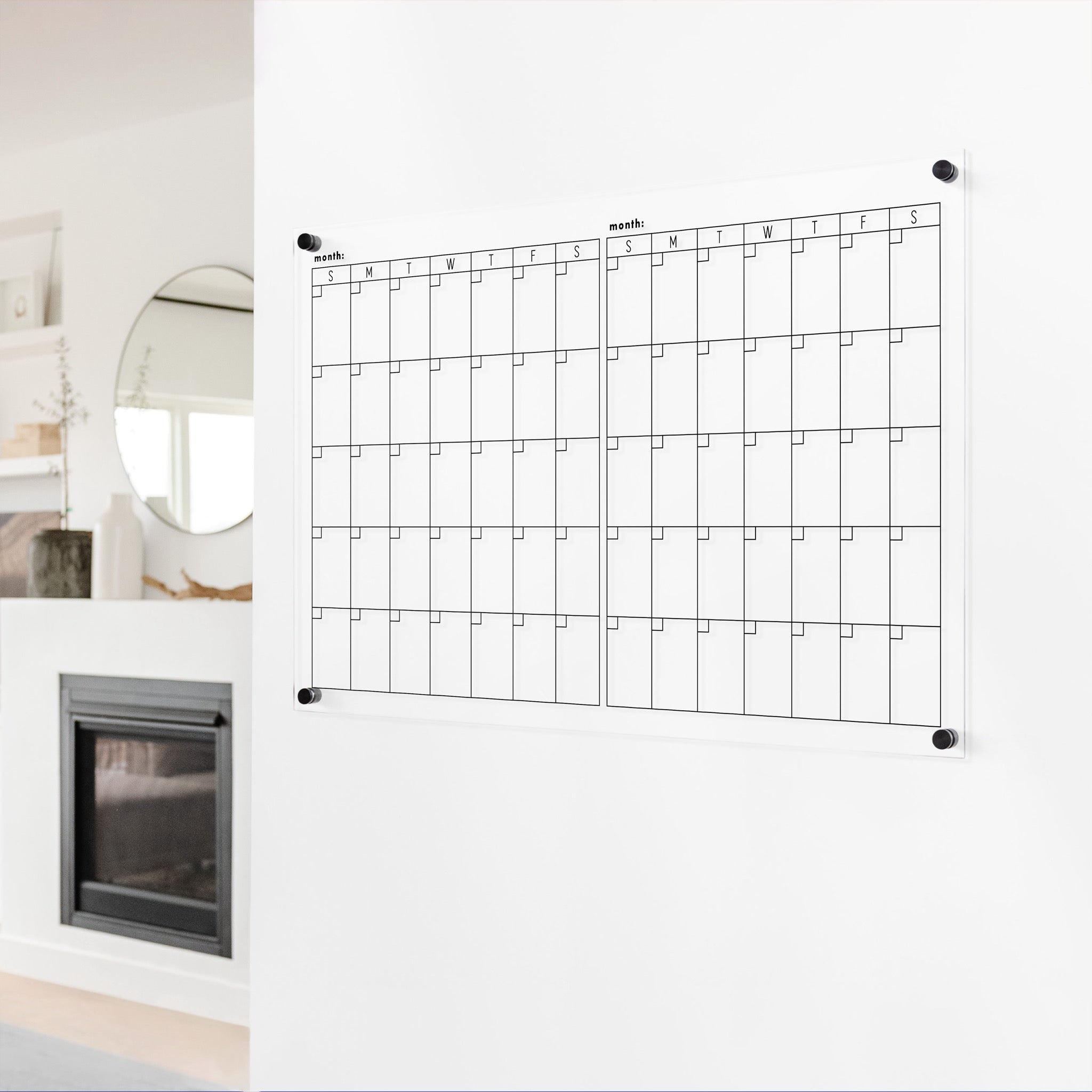A Dry-erase acrylic calendar with a two month design format hanging on the wall