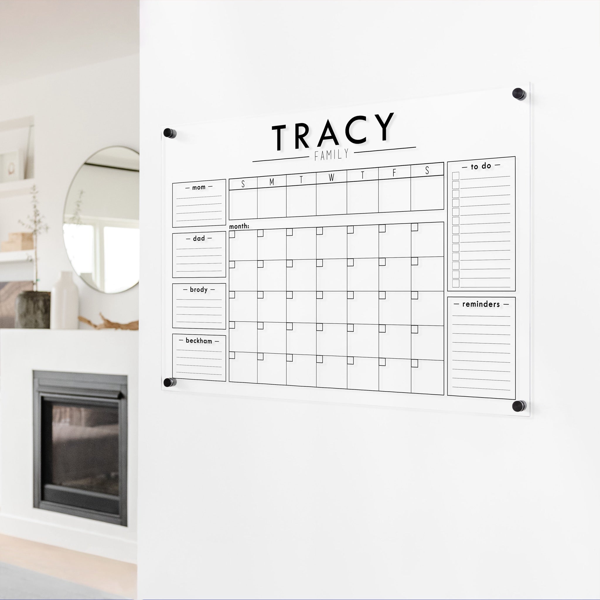 A Dry-erase calendar with a monthly and weekly format made of acrylic hanging on the wall