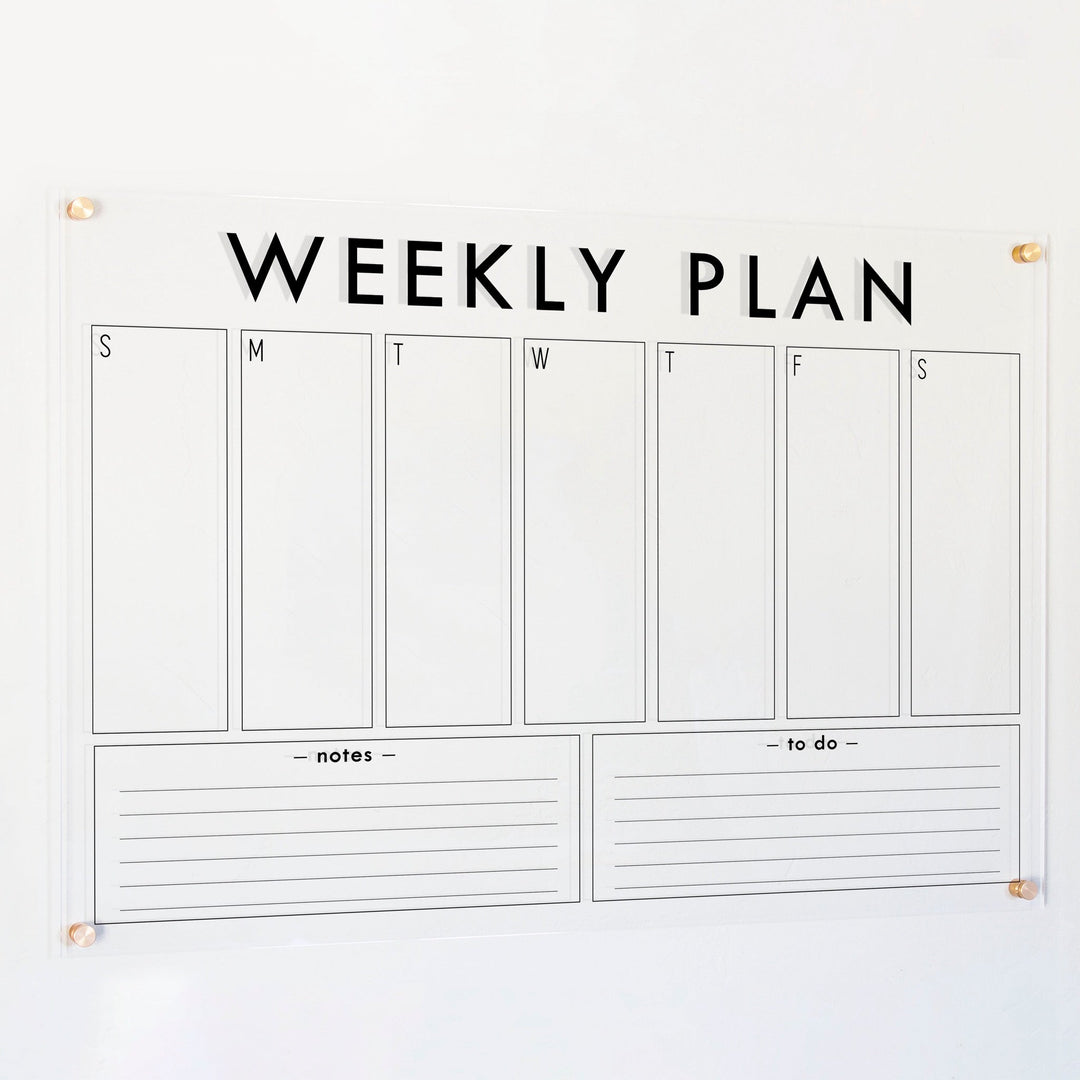 A Dry-erase weekly calender made of acrylic hanging on the wall