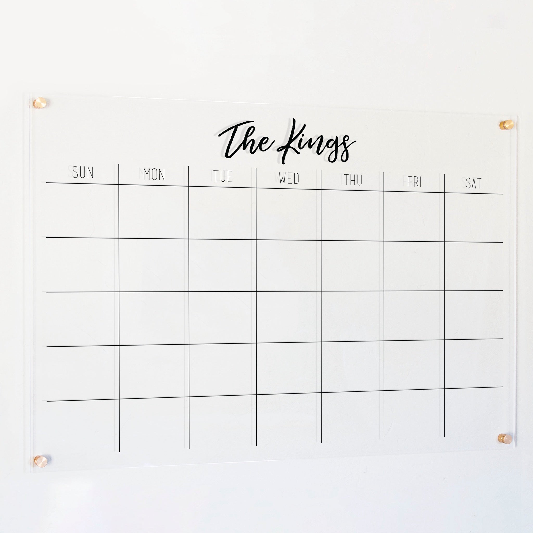 A Dry-erase monthly calender made of acrylic hanging on the wall