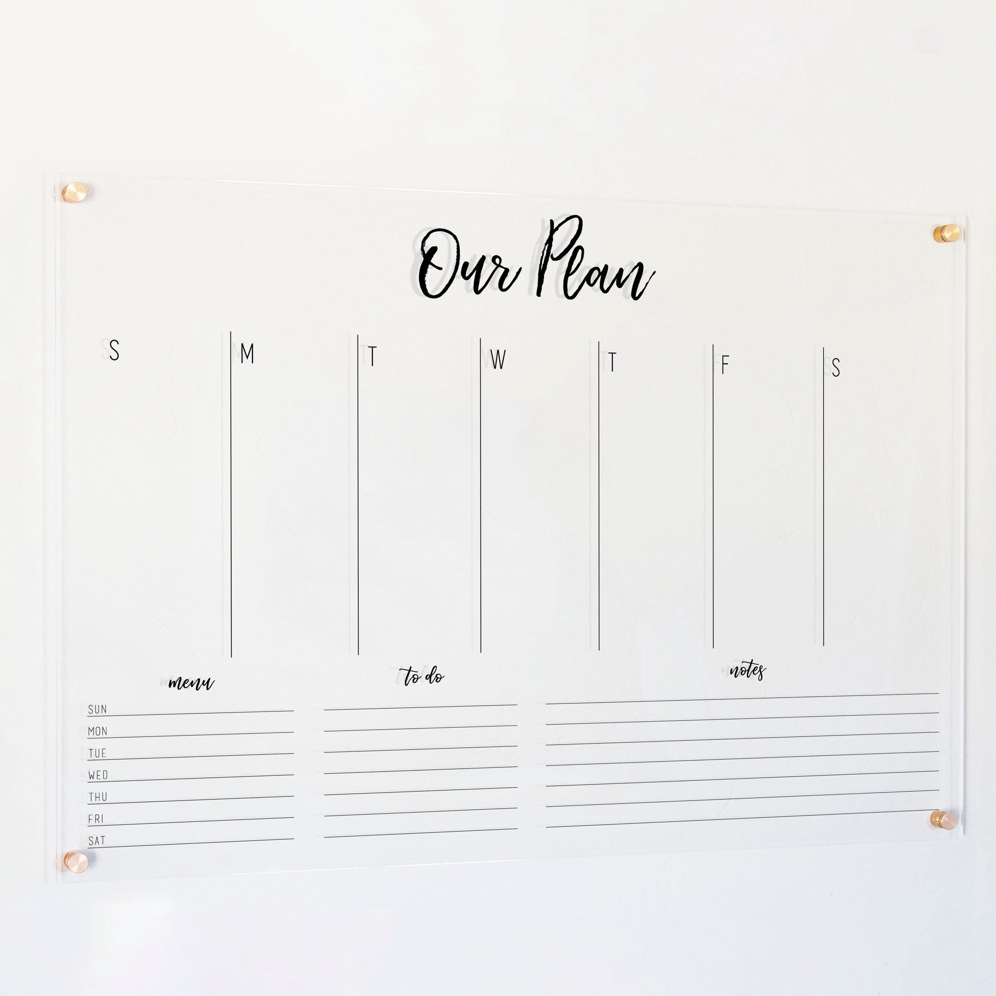A Dry-erase weekly calender made of acrylic hanging on the wall