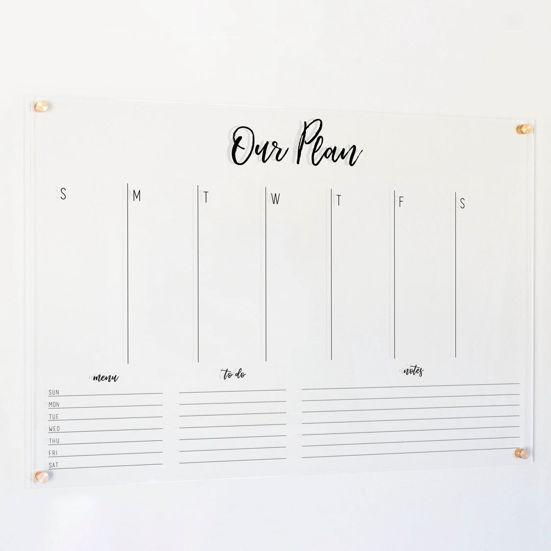 A Dry-erase weekly calender made of acrylic hanging on the wall