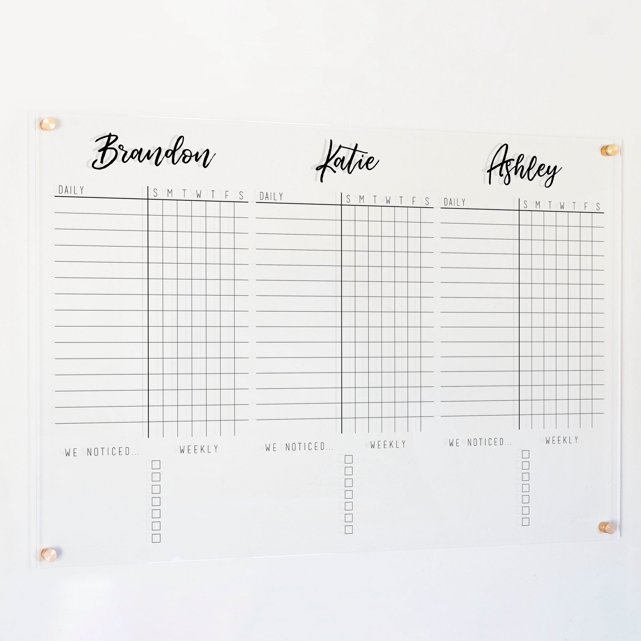 A Dry-erase acrylic chore chart hanging on the wall