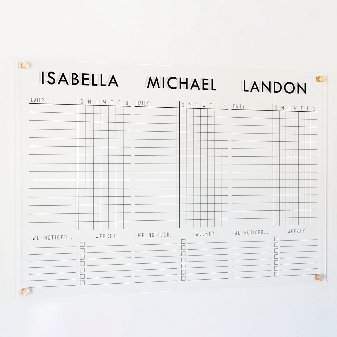 A Dry-erase acrylic chore chart hanging on the wall