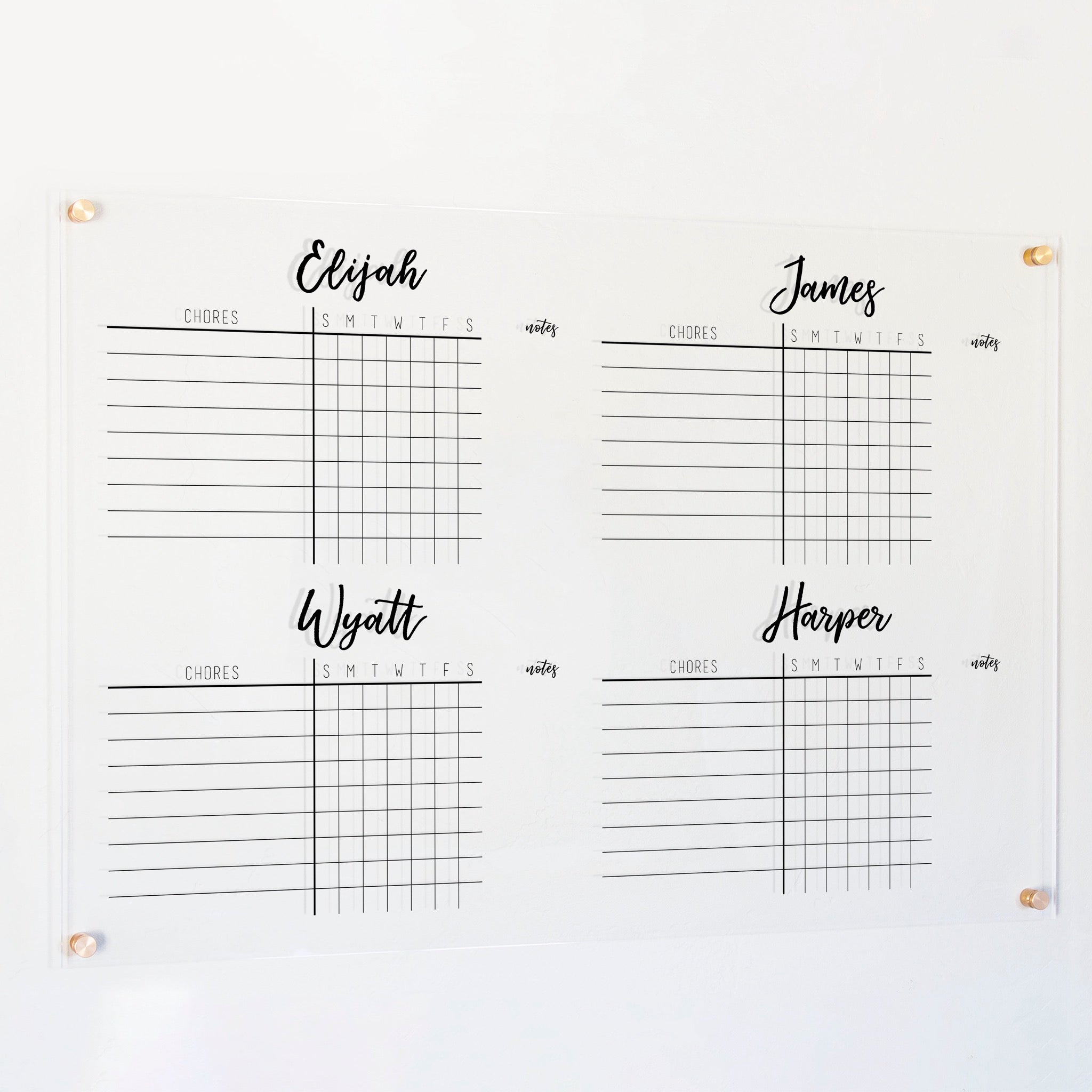 A Dry-erase acrylic chore chart hanging on the wall