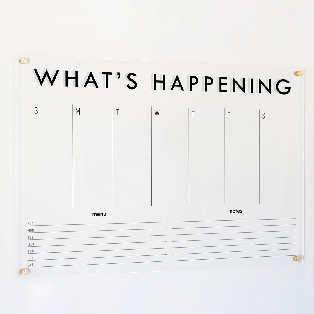 A Dry-erase weekly calender made of acrylic hanging on the wall