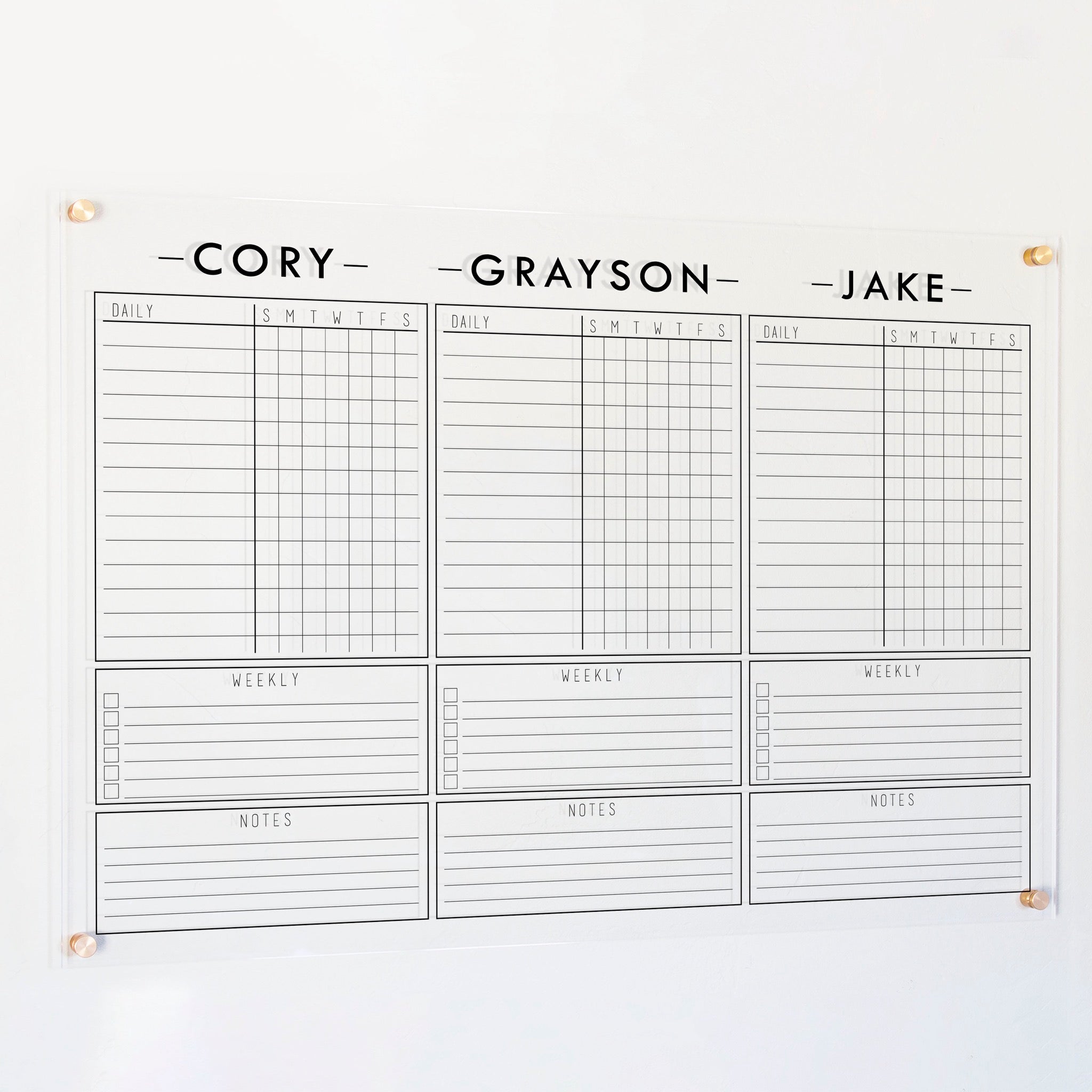 A Dry-erase acrylic chore chart hanging on the wall