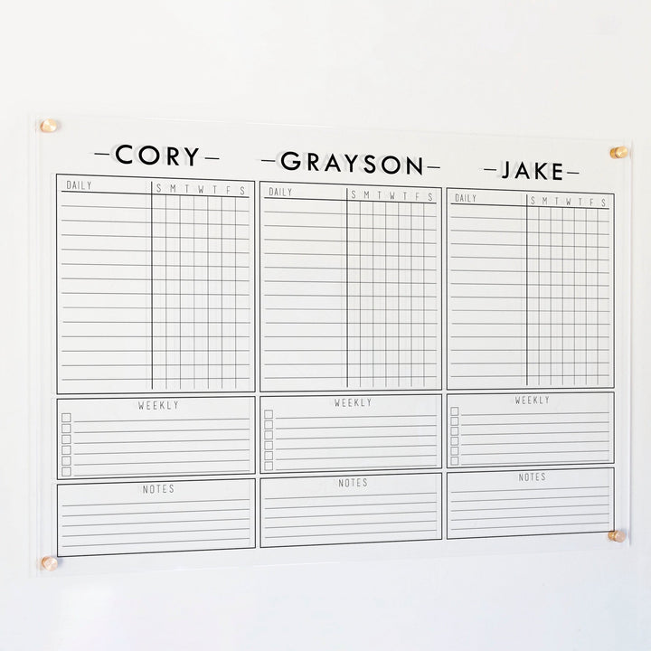 A Dry-erase acrylic chore chart hanging on the wall