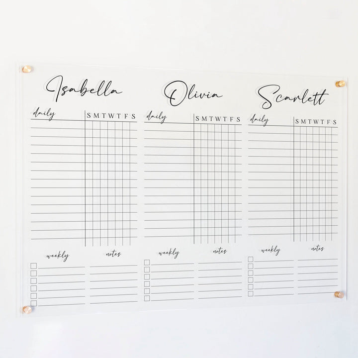 A Dry-erase acrylic chore chart hanging on the wall