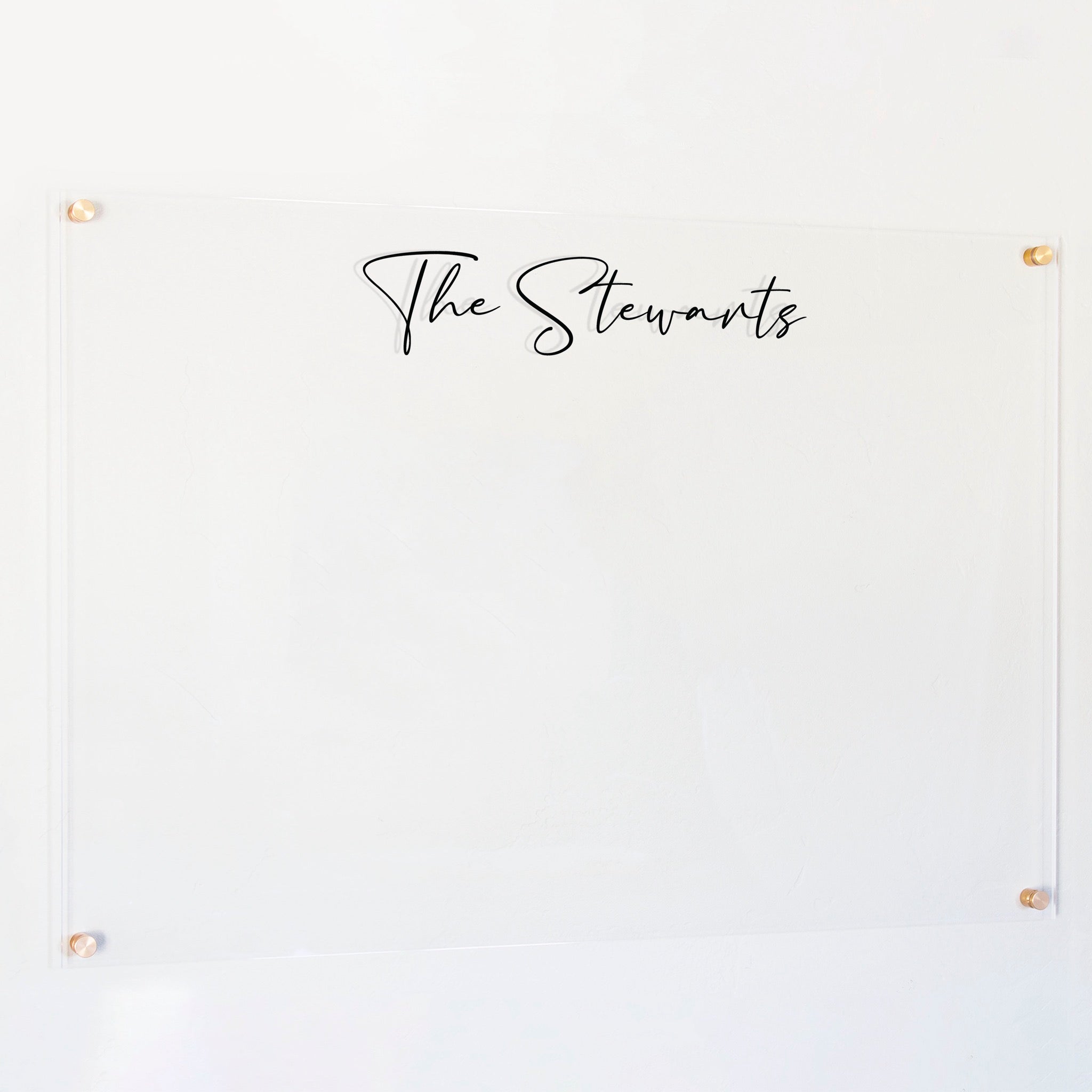 A dry-erase board made of clear acrylic with a custom title up top
