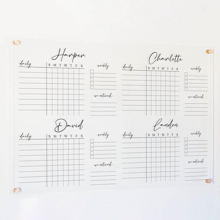 A Dry-erase acrylic chore chart hanging on the wall