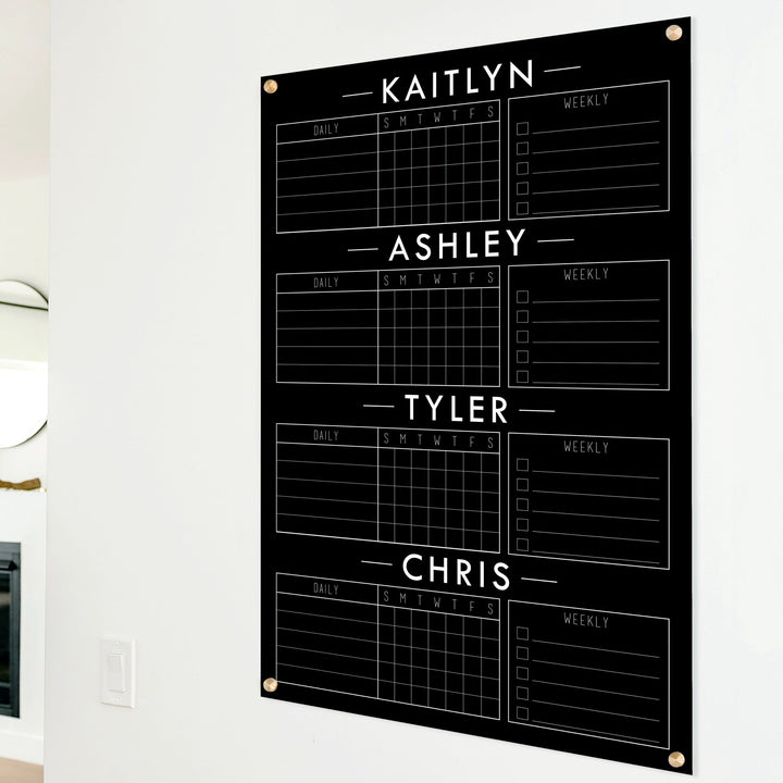 A Dry-erase acrylic chore chart hanging on the wall