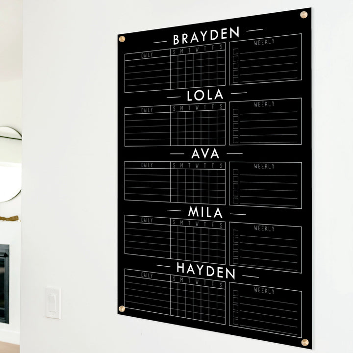 A Dry-erase acrylic chore chart hanging on the wall