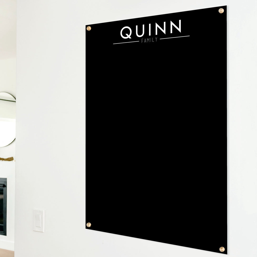 A dry-erase board made of clear acrylic with a custom title up top