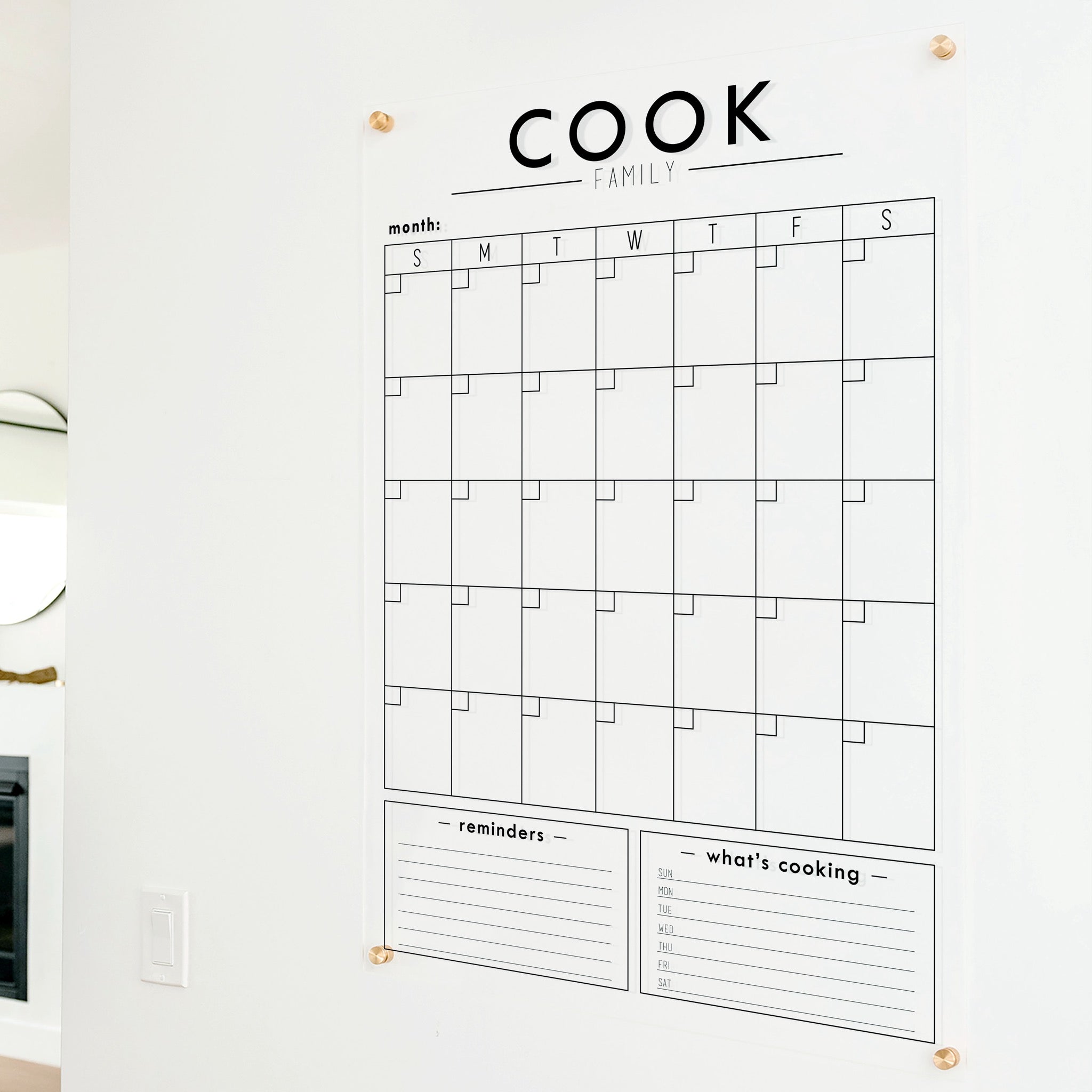 A Dry-erase monthly calender made of acrylic hanging on the wall