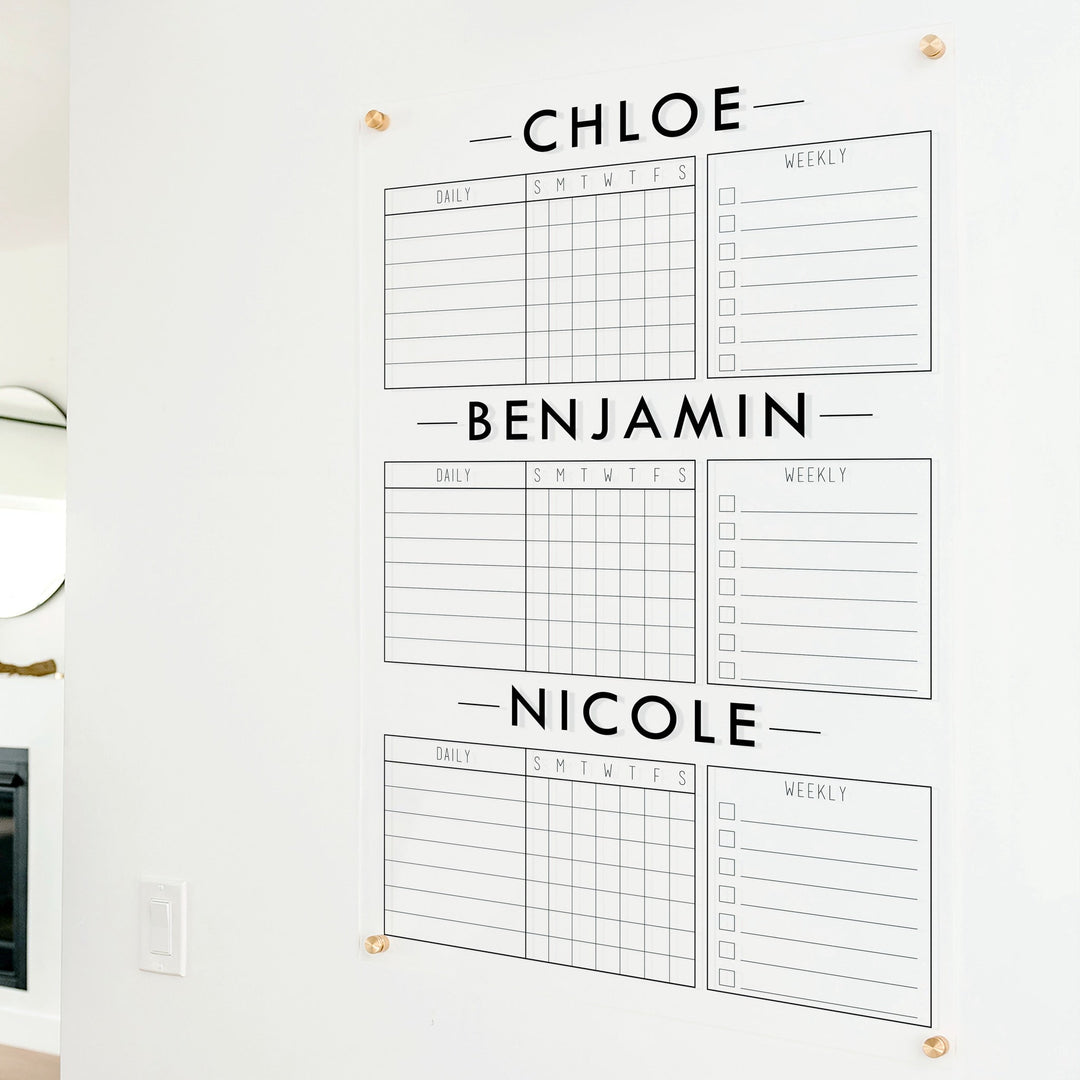 A Dry-erase acrylic chore chart hanging on the wall