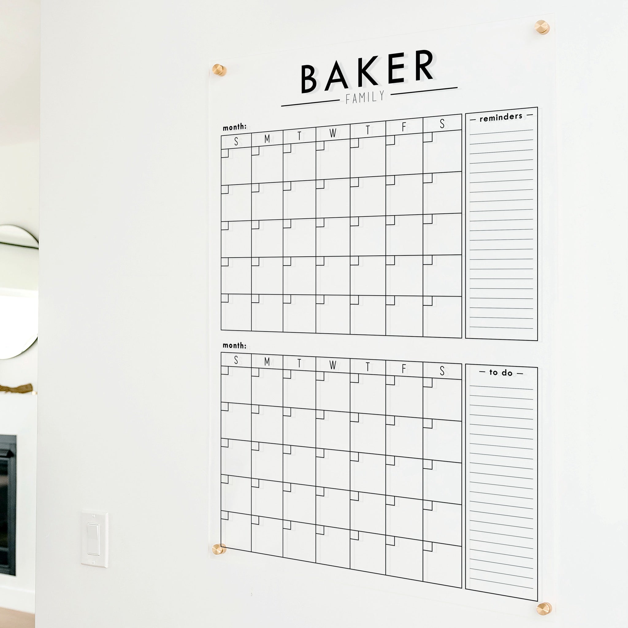 A Dry-erase acrylic calendar with a two month design format hanging on the wall