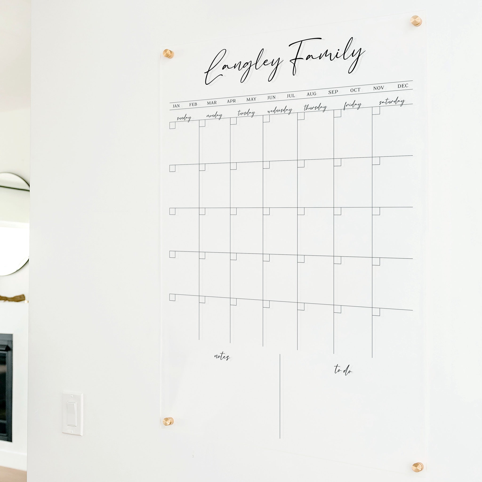 A Dry-erase monthly calender made of acrylic hanging on the wall