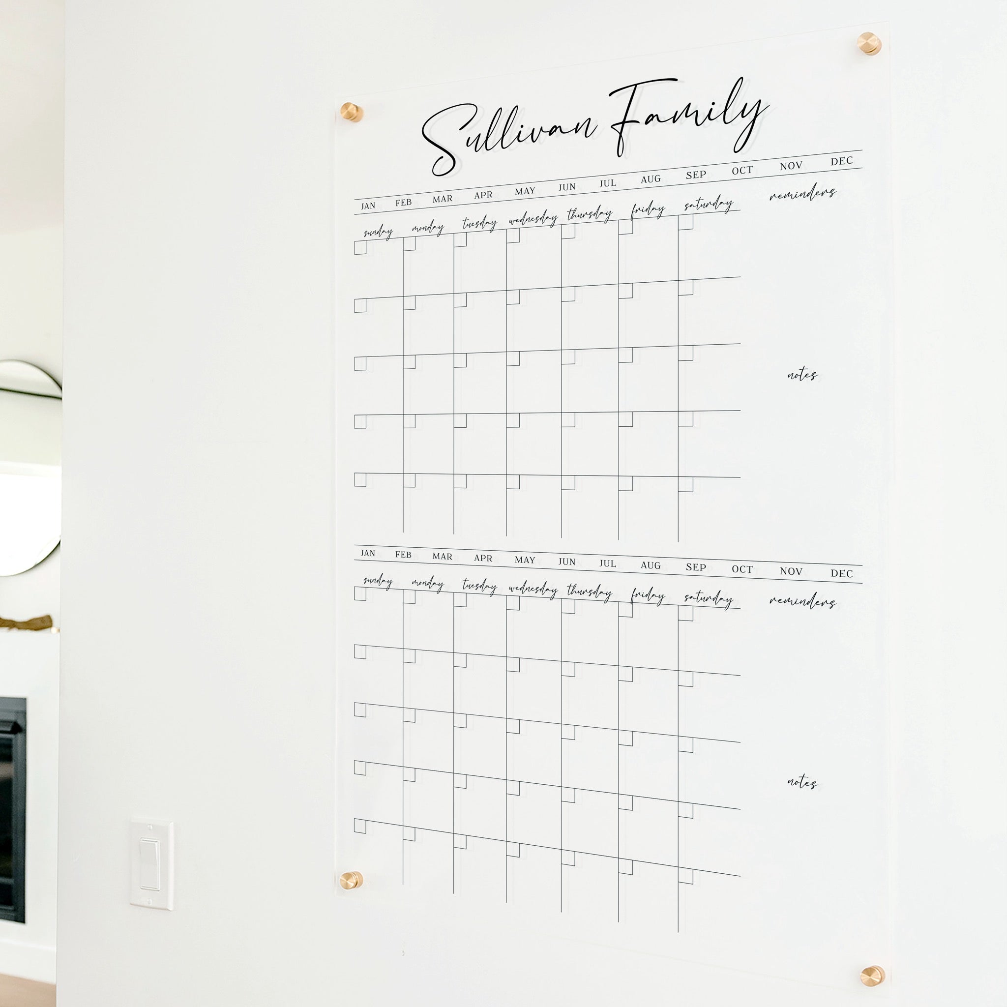 A Dry-erase acrylic calendar with a two month design format hanging on the wall