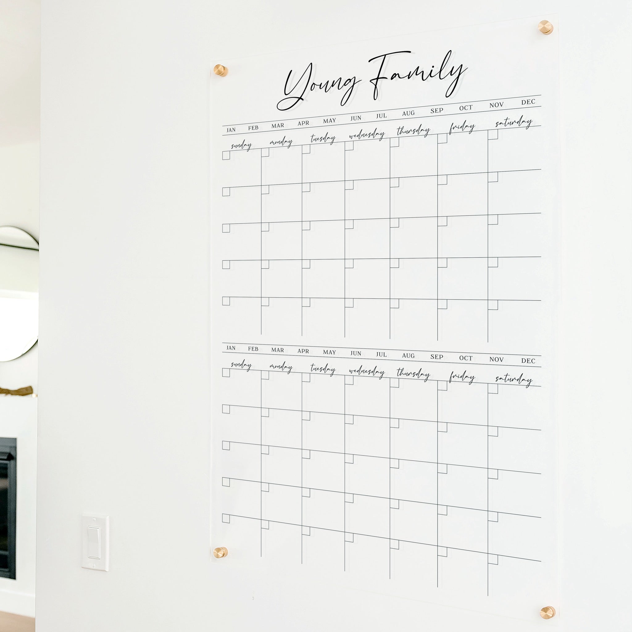 A Dry-erase acrylic calendar with a two month design format hanging on the wall