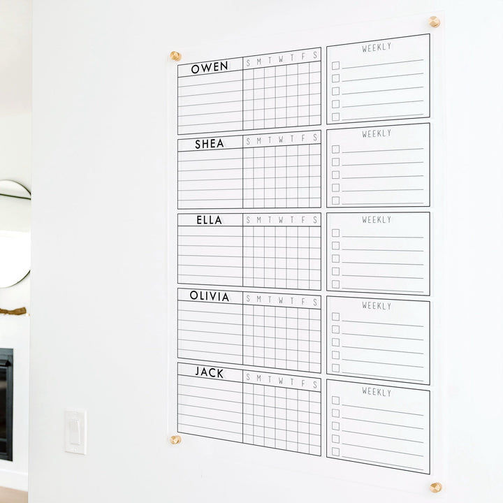 A Dry-erase acrylic chore chart hanging on the wall