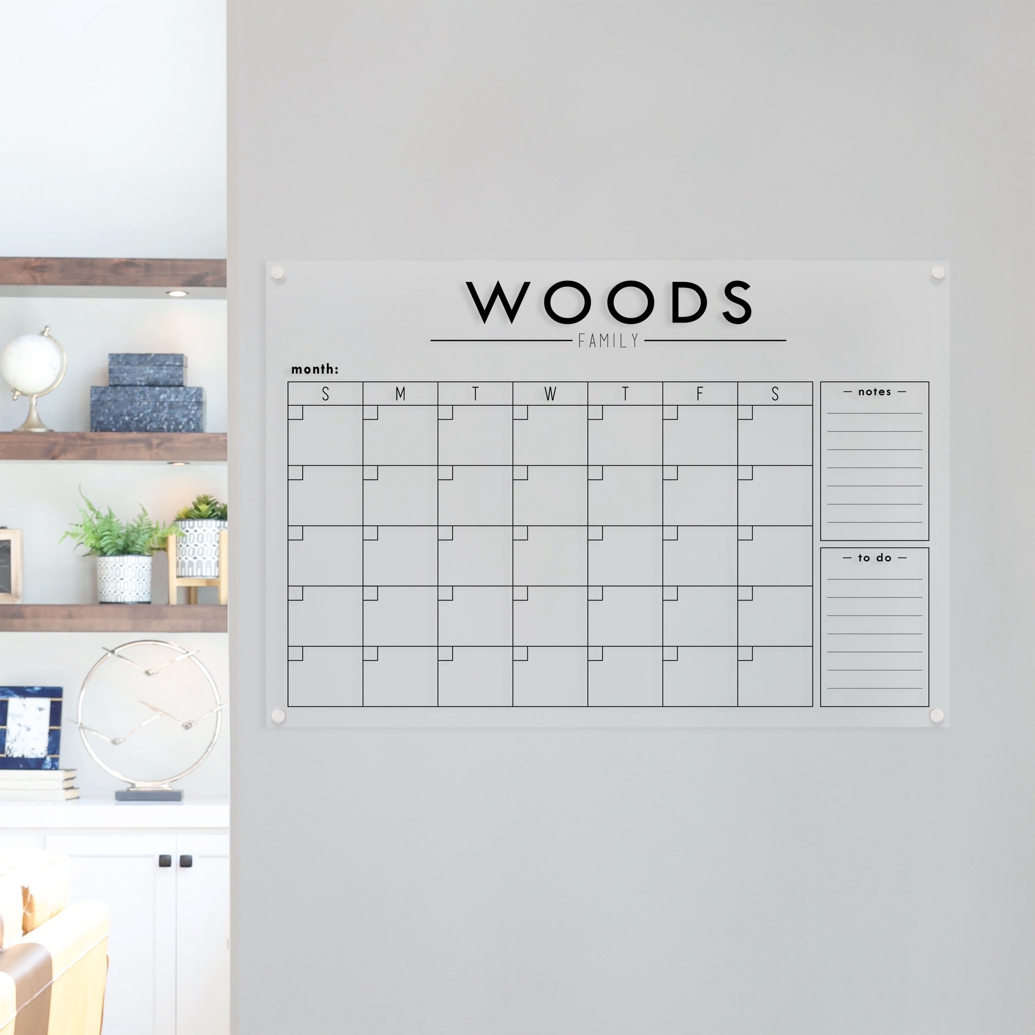 A Dry-erase monthly calender made of acrylic hanging on the wall