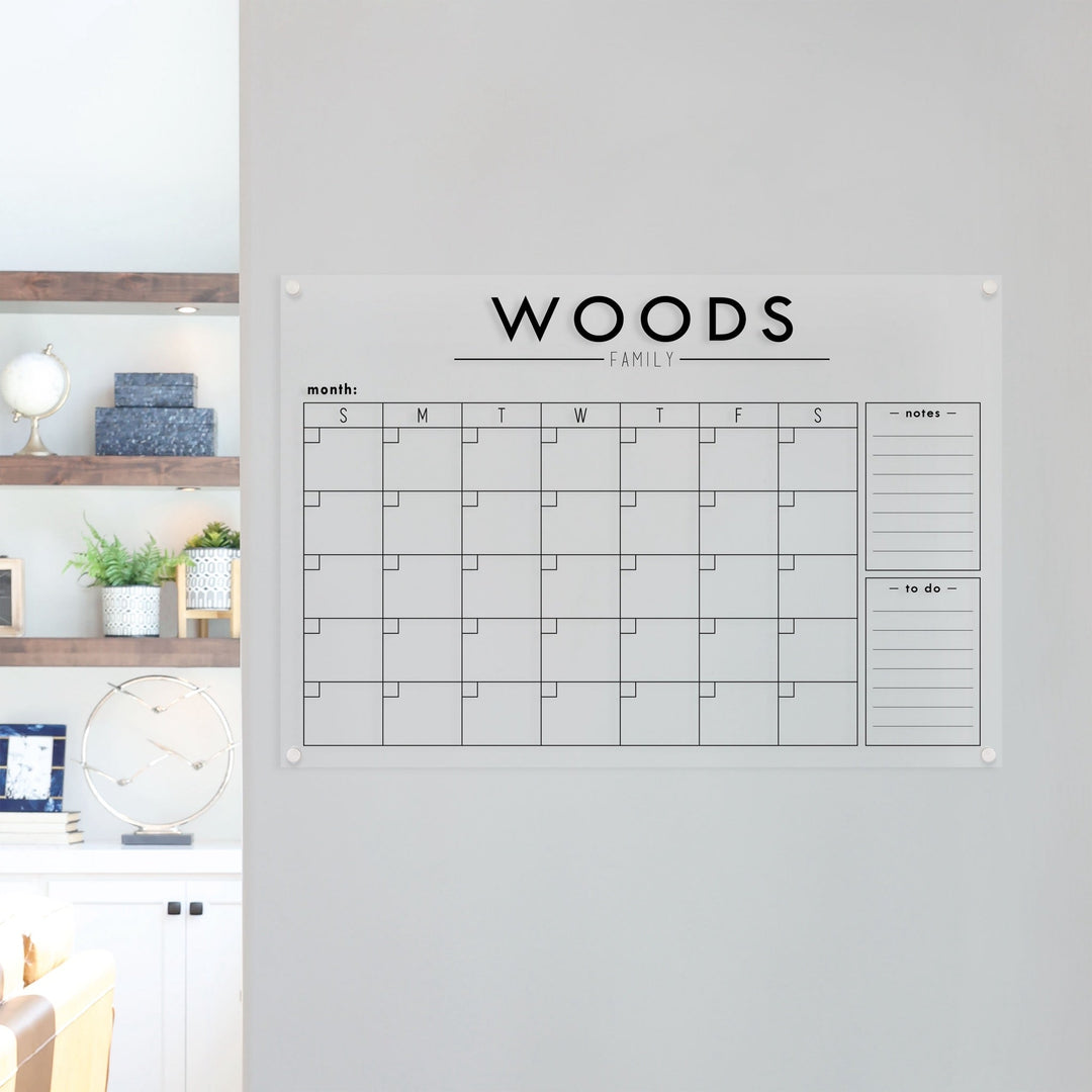 A Dry-erase monthly calender made of acrylic hanging on the wall