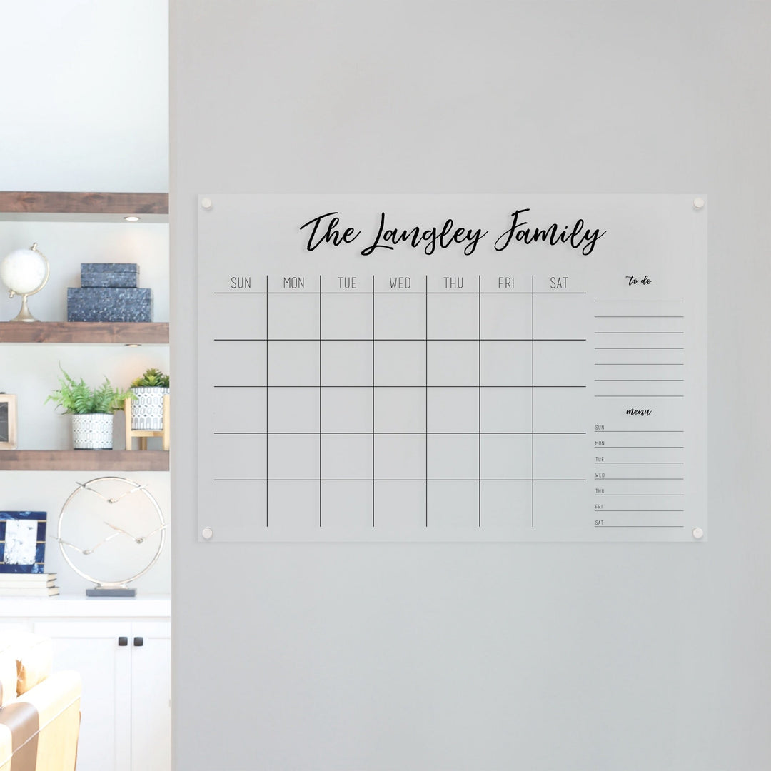 A Dry-erase monthly calender made of acrylic hanging on the wall
