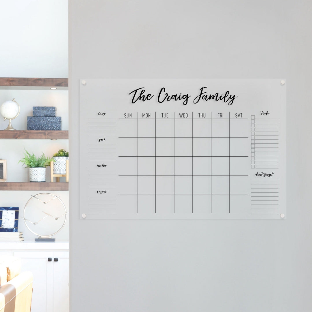 A Dry-erase family command center made of acrylic hanging on the wall