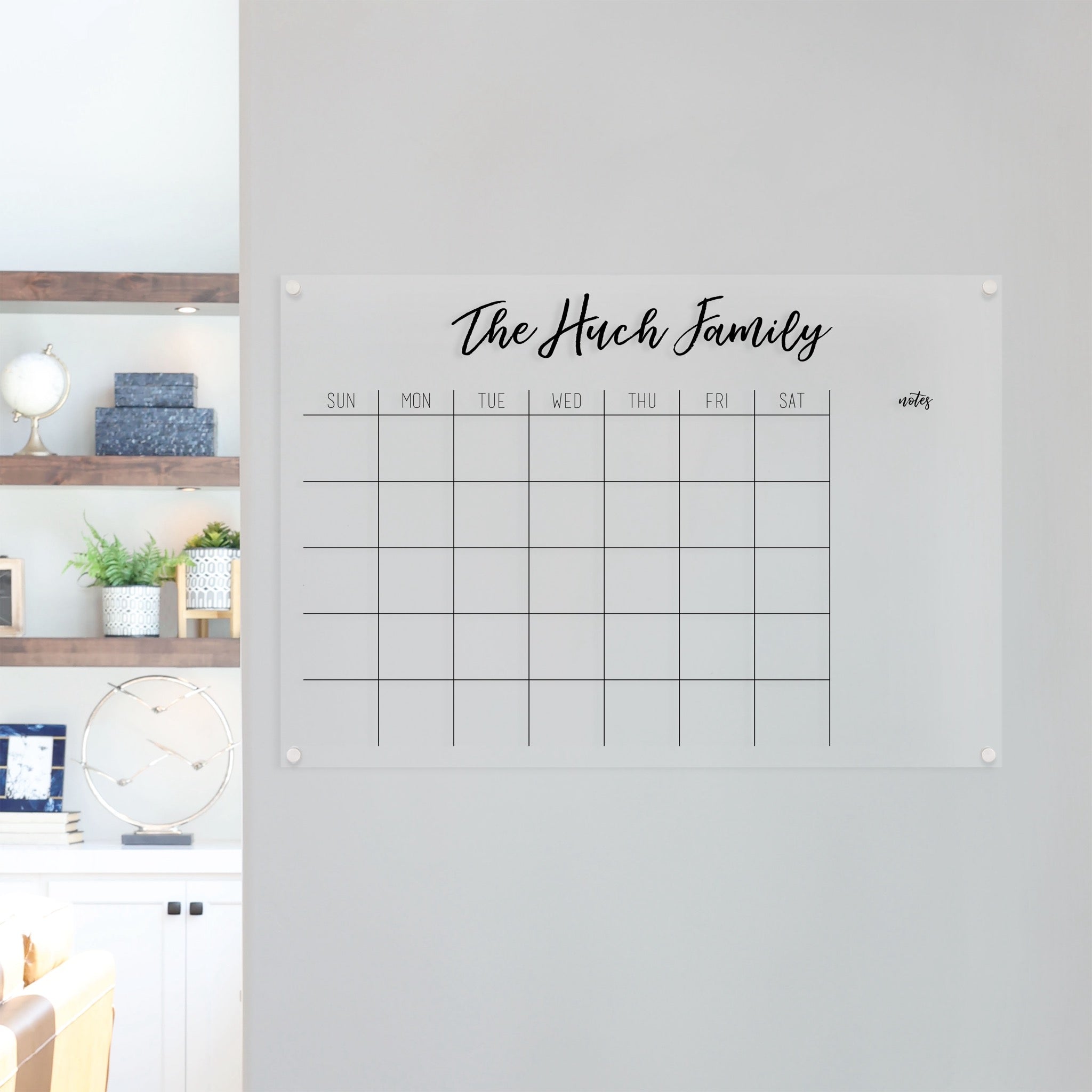A Dry-erase monthly calender made of acrylic hanging on the wall