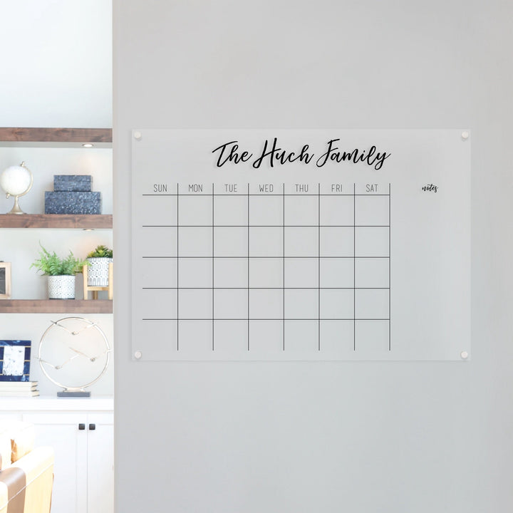 A Dry-erase monthly calender made of acrylic hanging on the wall