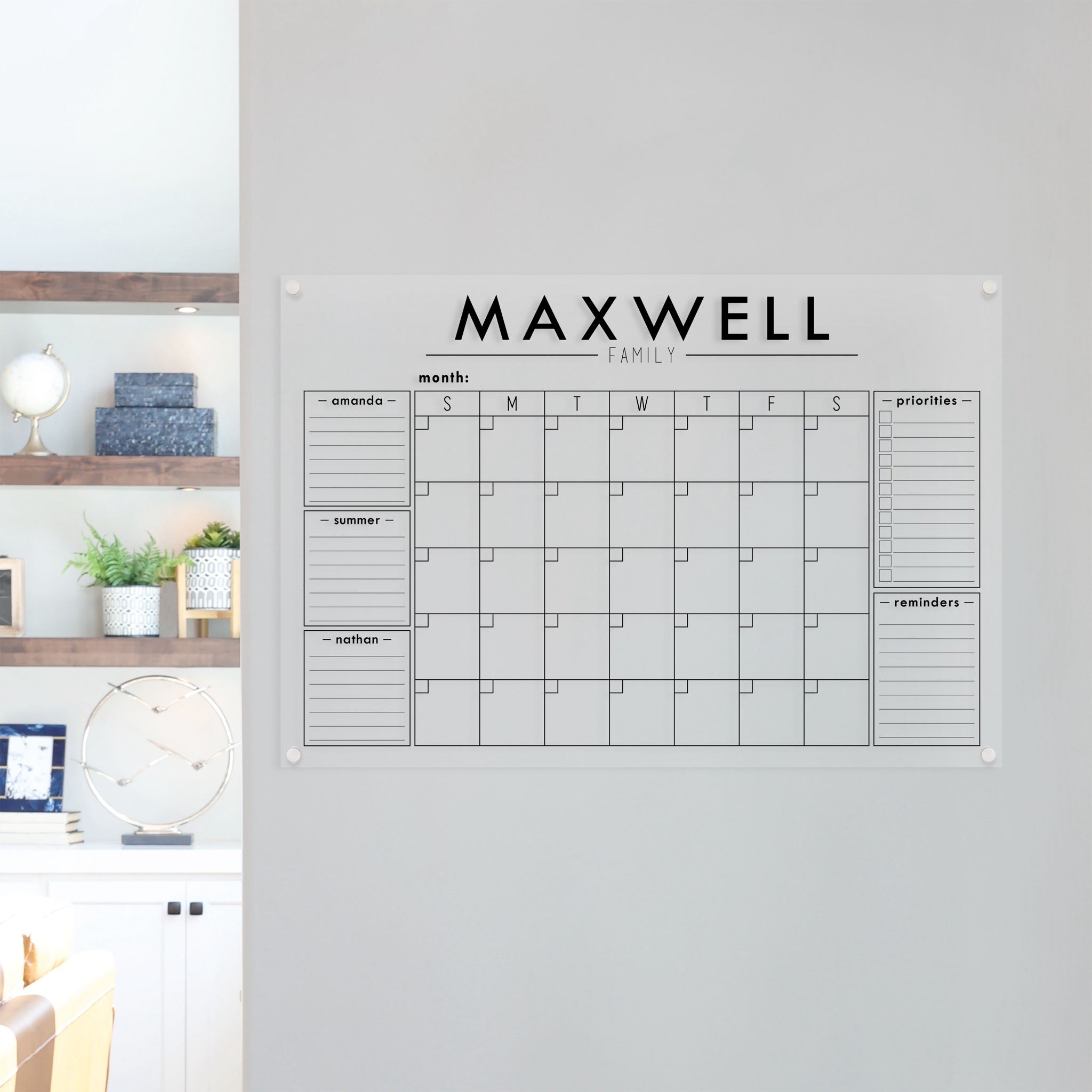 A Dry-erase family command center made of acrylic hanging on the wall