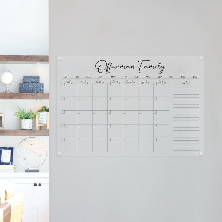 A Dry-erase monthly calender made of acrylic hanging on the wall