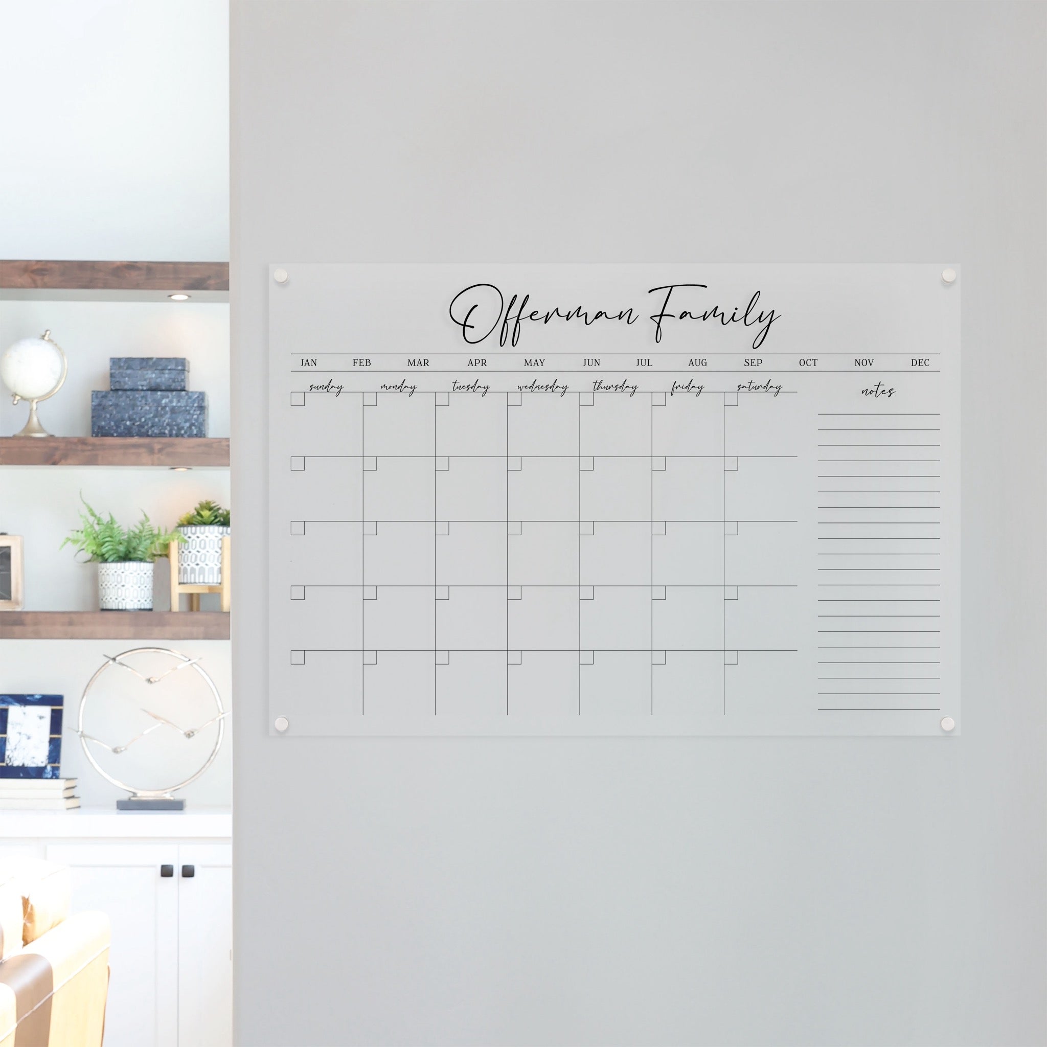 A Dry-erase monthly calender made of acrylic hanging on the wall