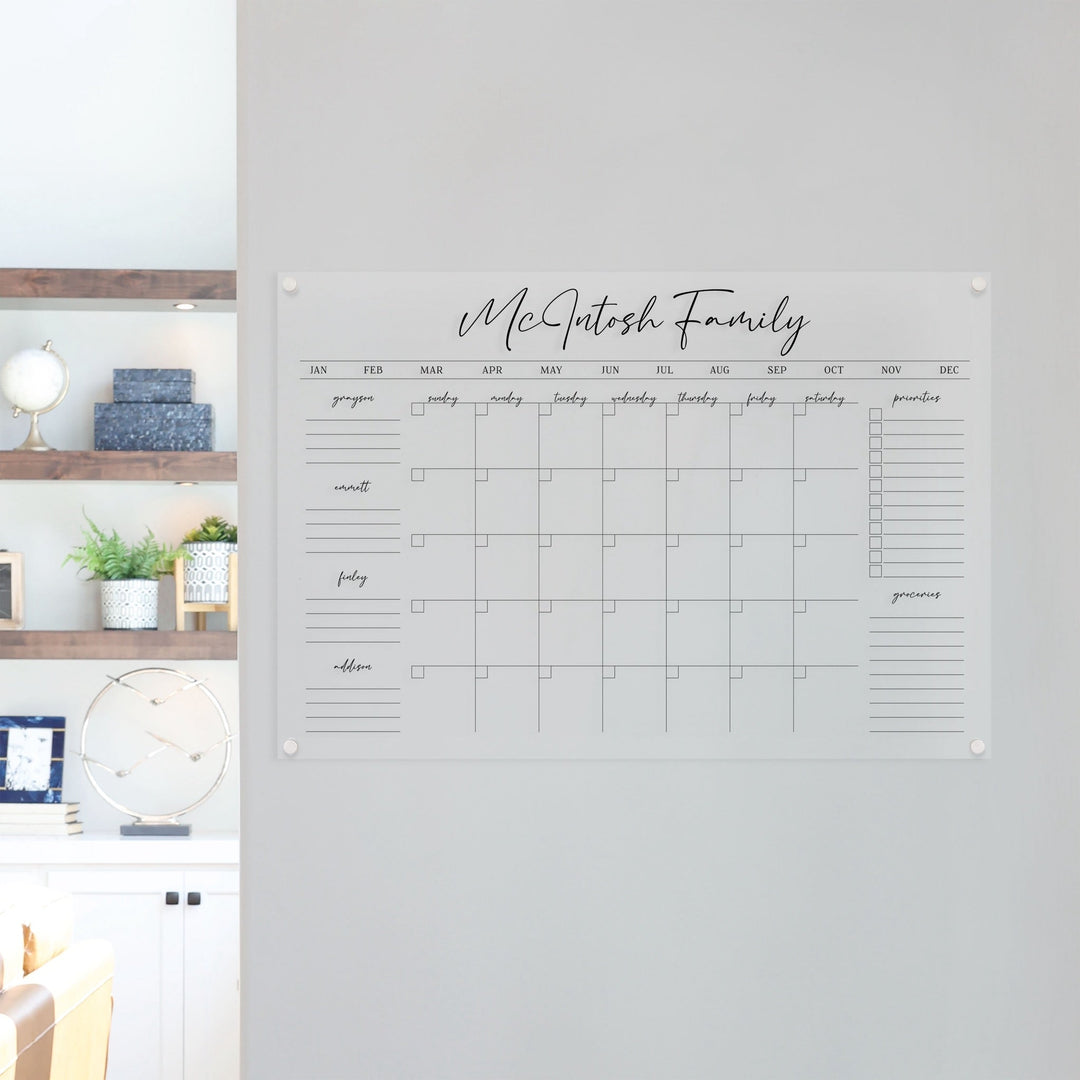 A Dry-erase family command center made of acrylic hanging on the wall