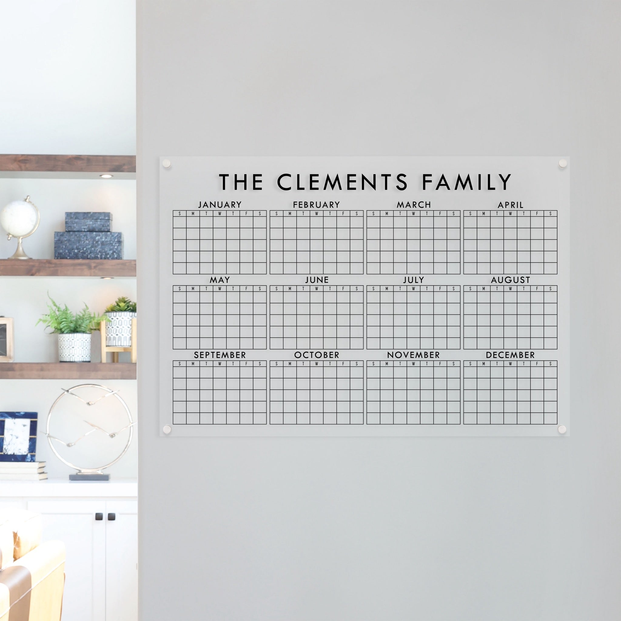 A dry-erase yearly calendar made of acrylic hanging up on the wall