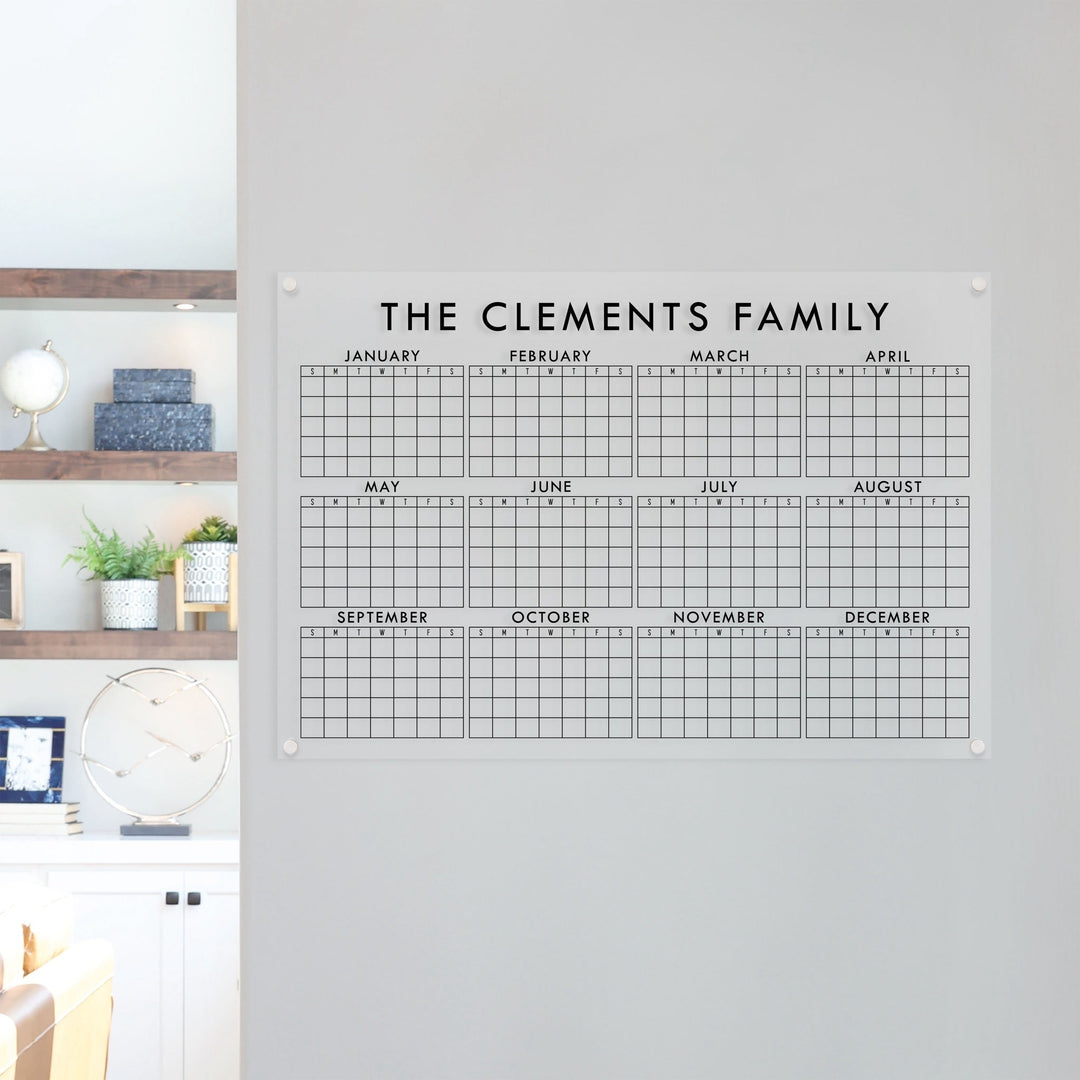 A dry-erase yearly calendar made of acrylic hanging up on the wall