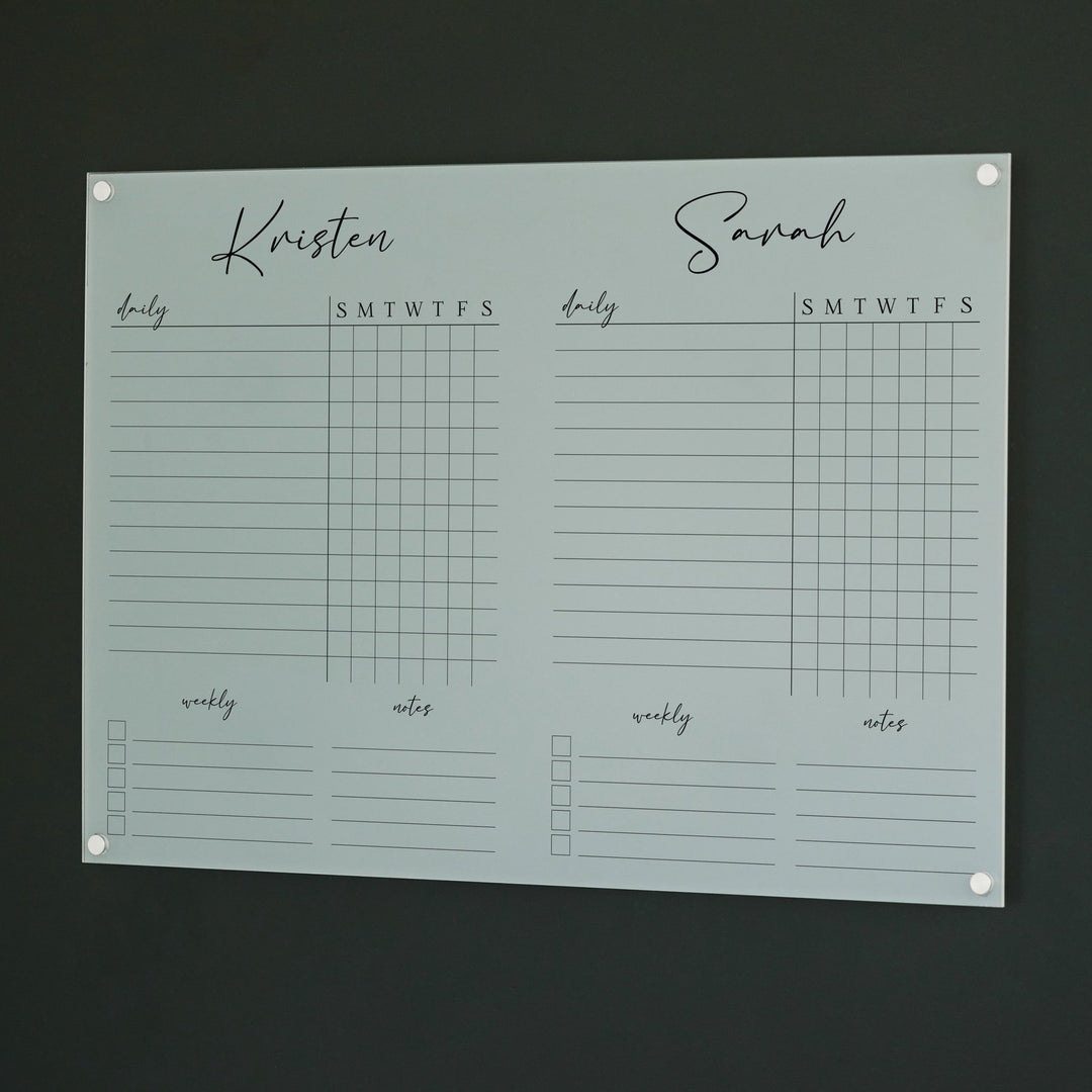 A Dry-erase acrylic chore chart hanging on the wall