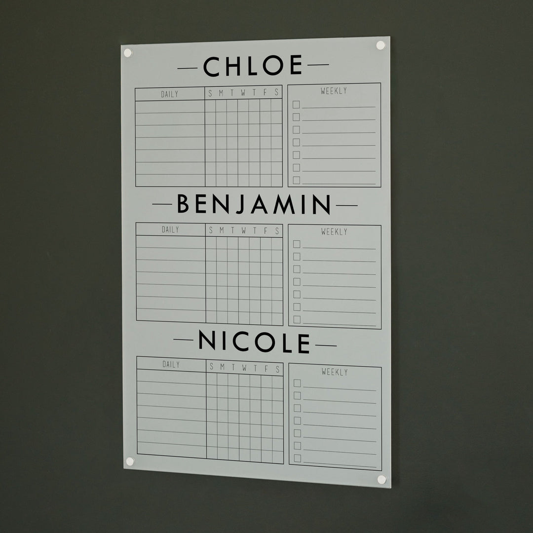A Dry-erase acrylic chore chart hanging on the wall