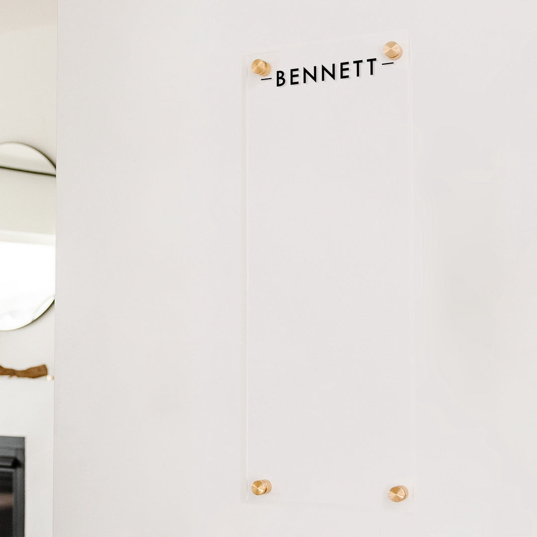 A dry-erase board made of clear acrylic with a custom title up top